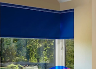 Roller blinds in the corner of a room