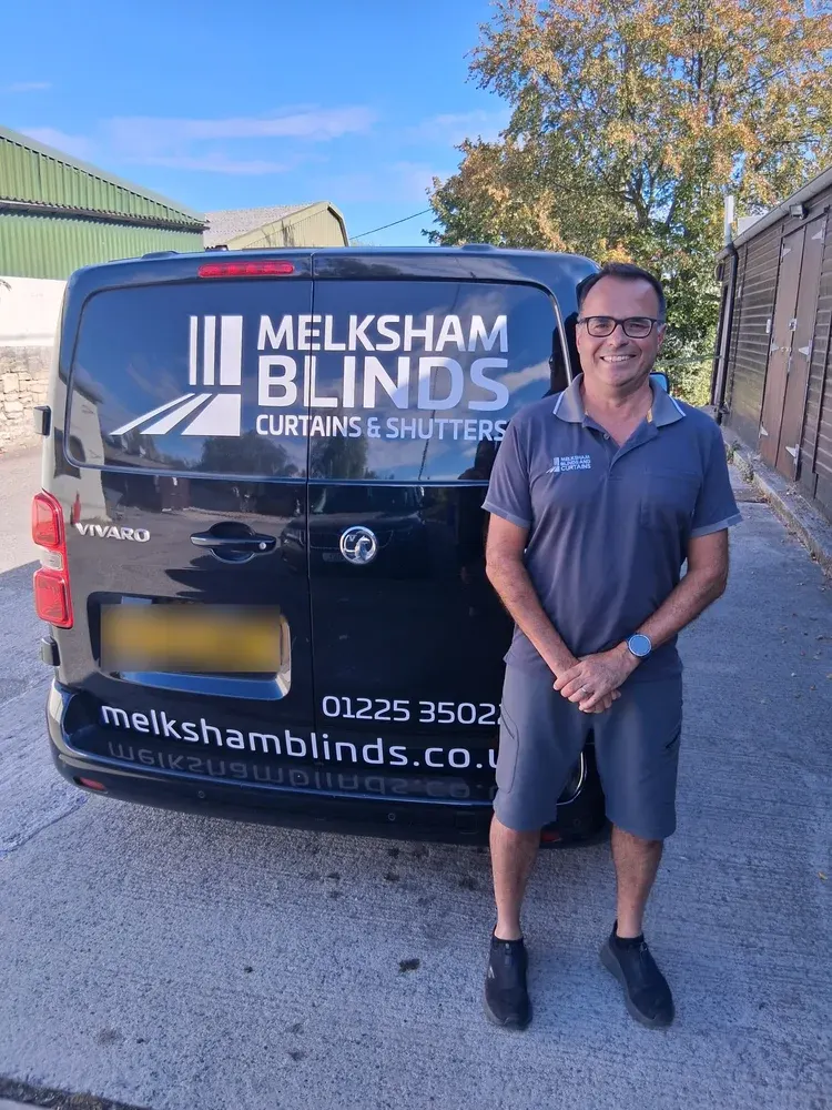 Simon Whitcroft of Melksham Blinds standing beside the branded company van